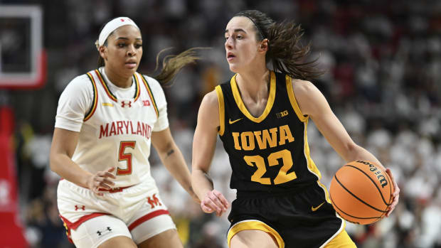 Iowa Hawkeyes guard Caitlin Clark (22) looks to pass as Maryland Terrapins guard Brinae Alexander (5) defends during the fist half at Xfinity Center.